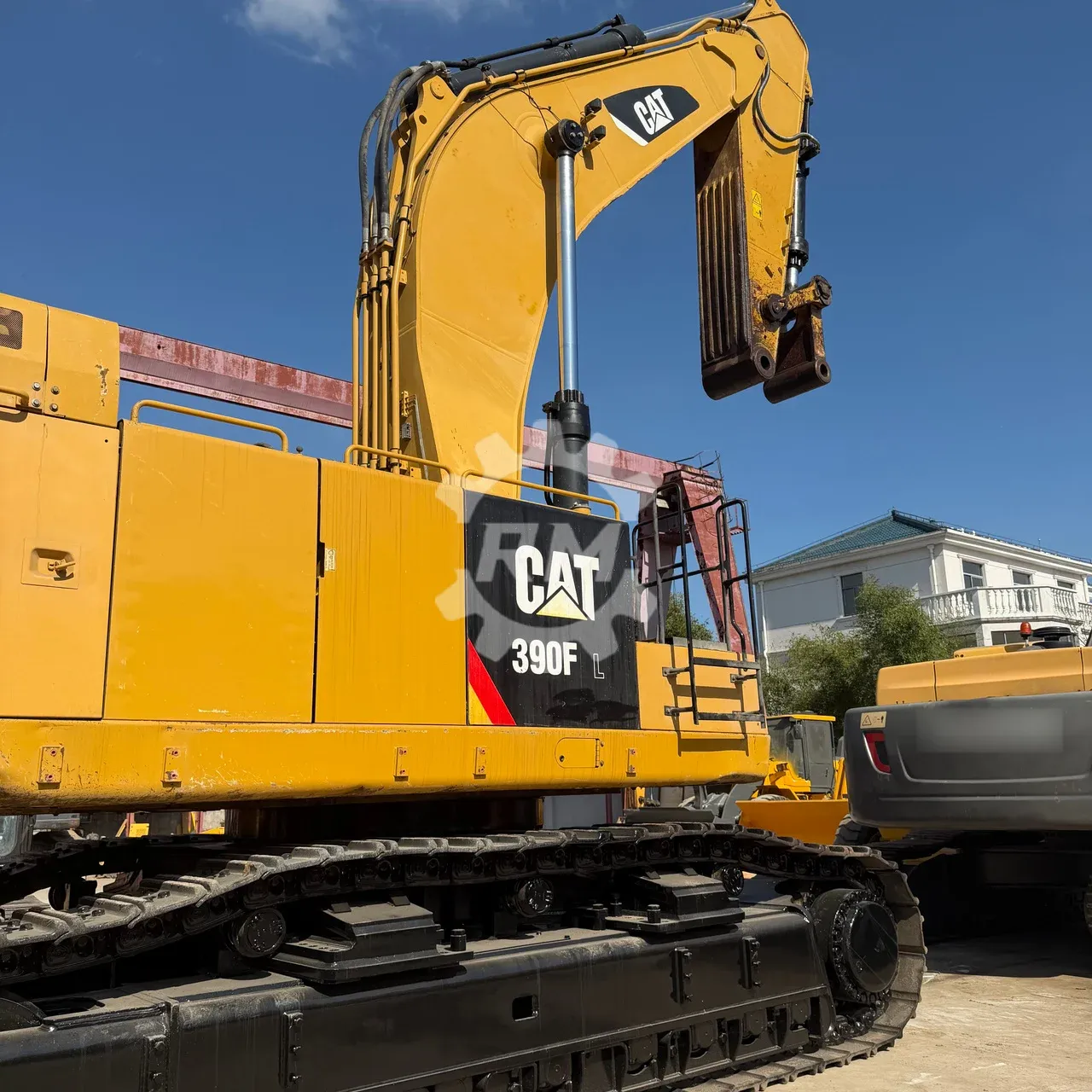 CAT 390F L model marking, front linkage and stick end without an installed bucket, with visible paint wear.