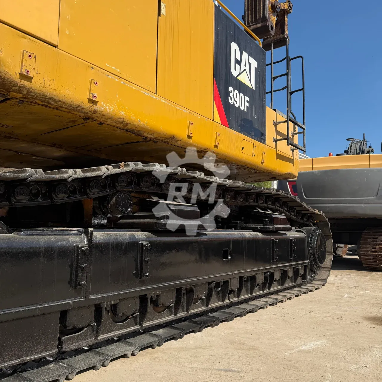 Close-up of the CAT 390F L tracks, rollers and lower frame.