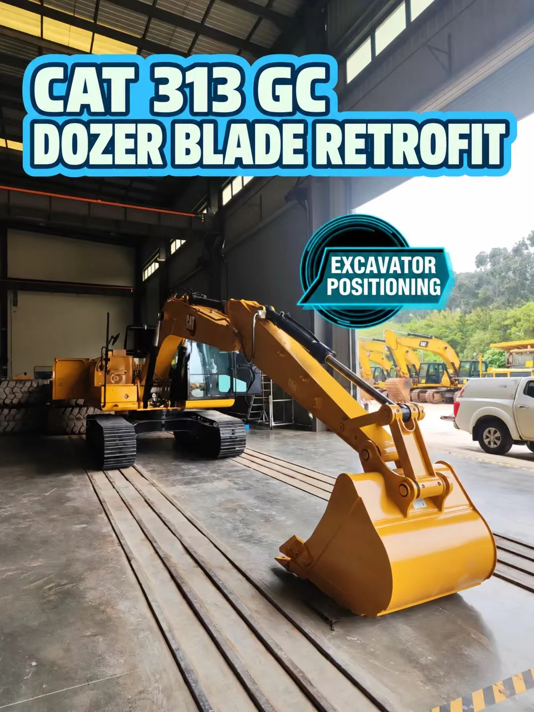 CAT 313 GC with bucket extended inside the workshop before blade installation.