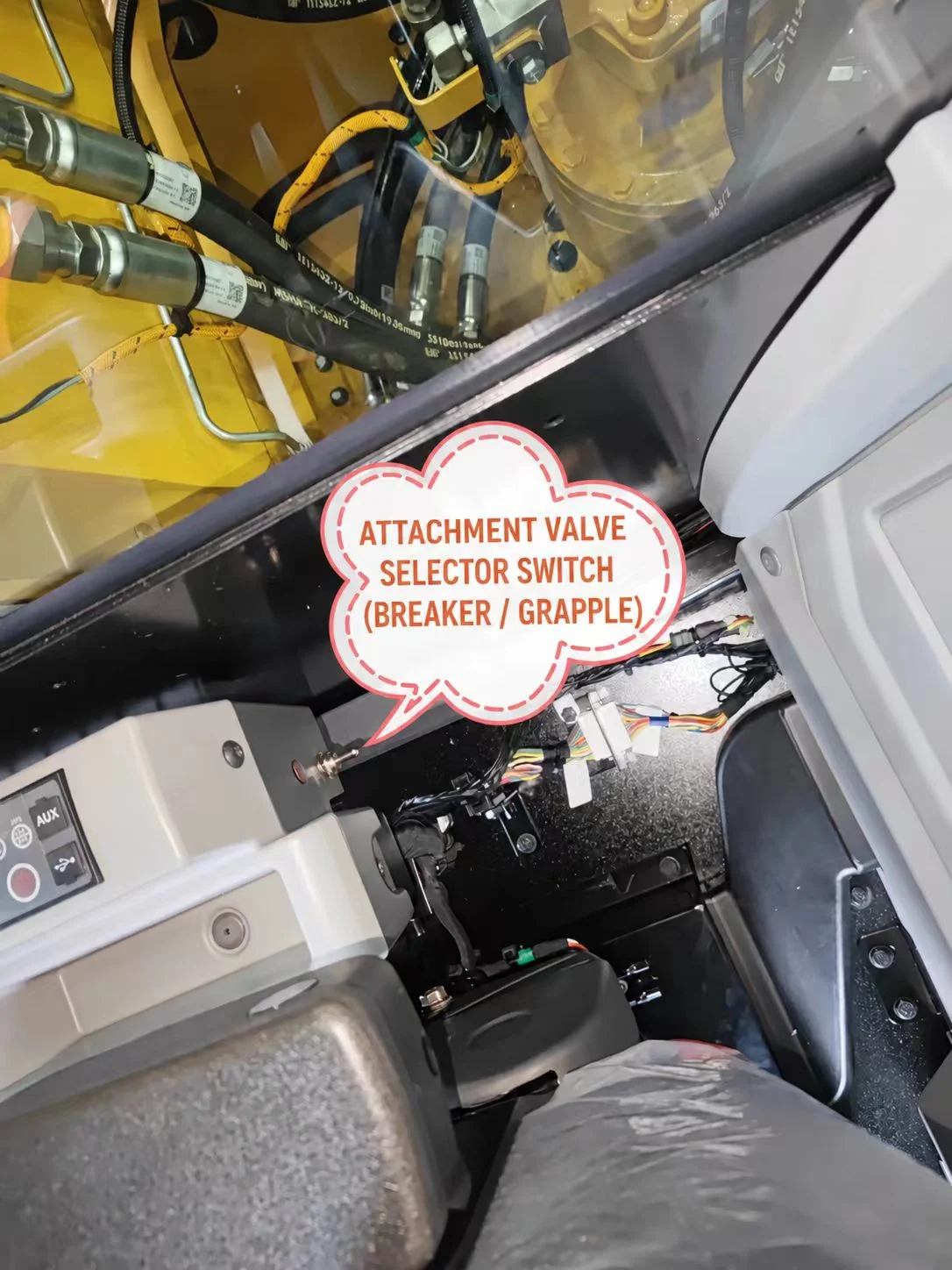 Cab-side attachment selector switch and wiring in the excavator installation work area.