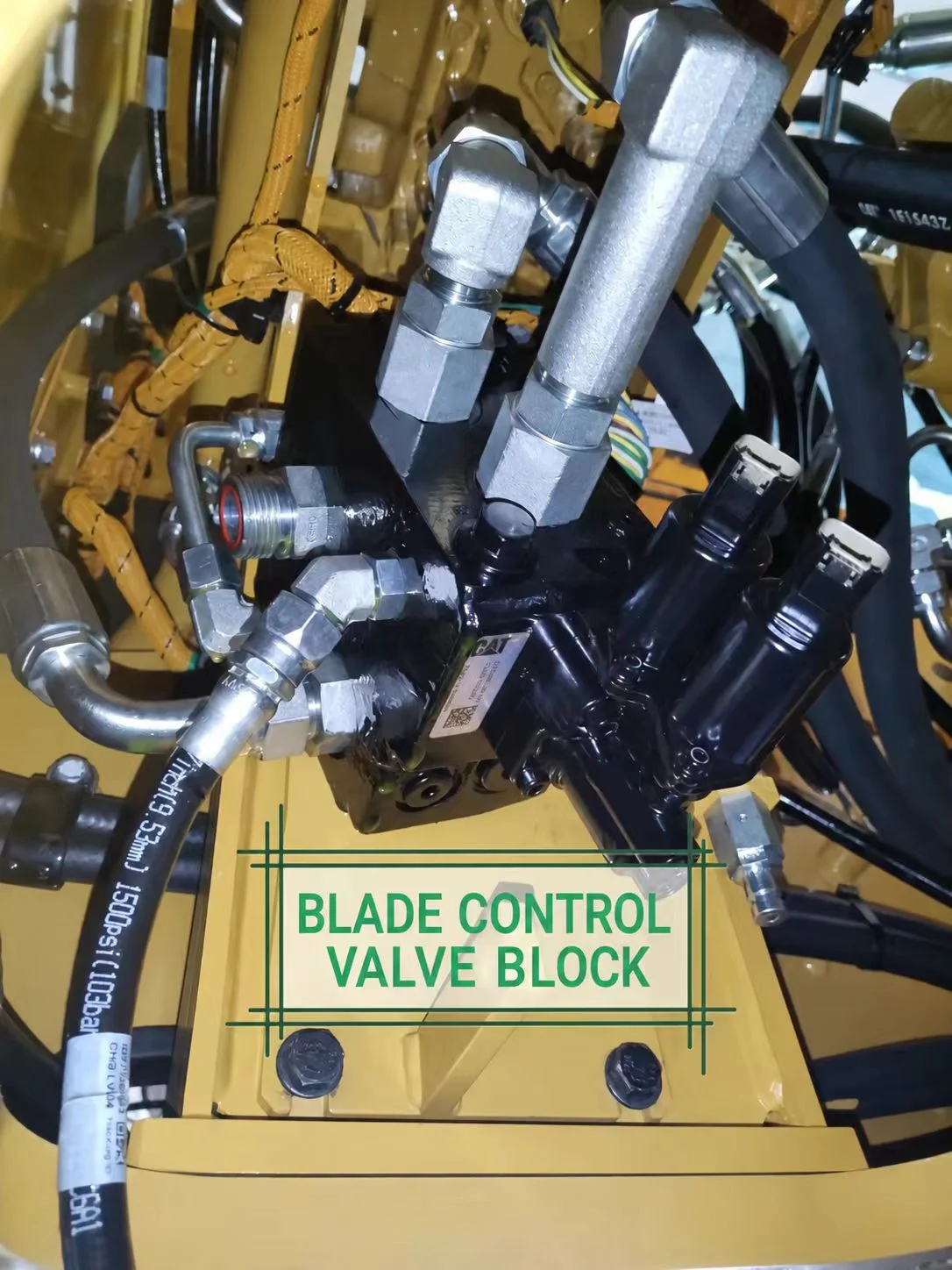Installed blade control valve block with hose connections inside the excavator.