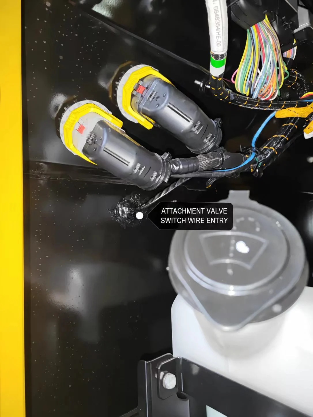 Control wire entry near the excavator cab electrical connectors.